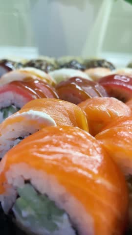 Sushi roll set, rolls with salmon, tuna, eel, shrimp, sesame, closeup, sushi japanese food, seafood, advertising sushi rolls, top view Royalty-Free Stock Footage #3473789145