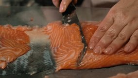Cut salmon into pieces. . High quality 4k footage