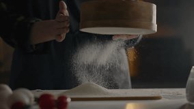 Dough preparation, Chef preparing dough for baking. Sifts flour with a sieve Baking workshop Professional assistant cook Combines ingredients for dough In the culinary workshop confectionery - Powered by Shutterstock - Get 15% off with code: PIKWIZARD15