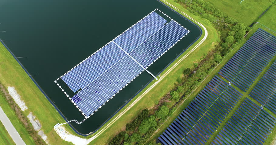 Production of sustainable photovoltaic electricity on water surface with zero emission. Floating solar panels at renewable electrical power plant for producing clean electric energy