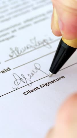 Close-up shot of young woman hands with pen signing contract. Business agreement concept. Vertical HD screen video.