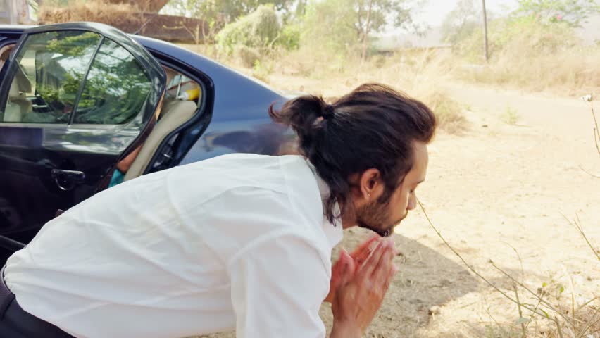 Young man washing his face with face wash, Man using bottle water for face wash, Man getting ready on shooting location, Men on rural setting by his car, Businessman washing face outdoor, Asian, India