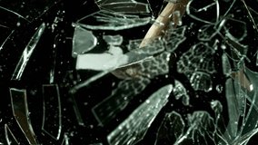 Super slow motion of glass-breaking hammer, shattering against black background . Filmed on high speed cinema camera, 1000 fps . - Powered by Shutterstock - Get 15% off with code: PIKWIZARD15