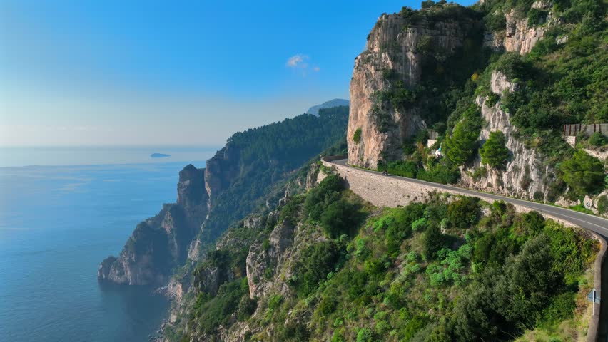 Motorcycle speeds through the curves overlooking the sea of the Amalfi Coast.
Positano, Amalfi, panoramic aerial view of the coast.