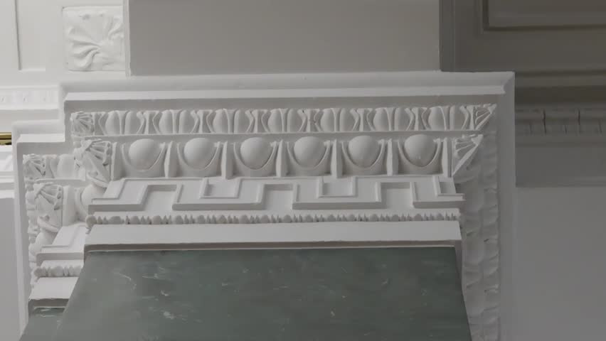 an ornate white plasterwork frieze with geometric and egg-and-dart patterns, indicating classical architecture or interior design. - Powered by Shutterstock - Get 15% off with code: PIKWIZARD15