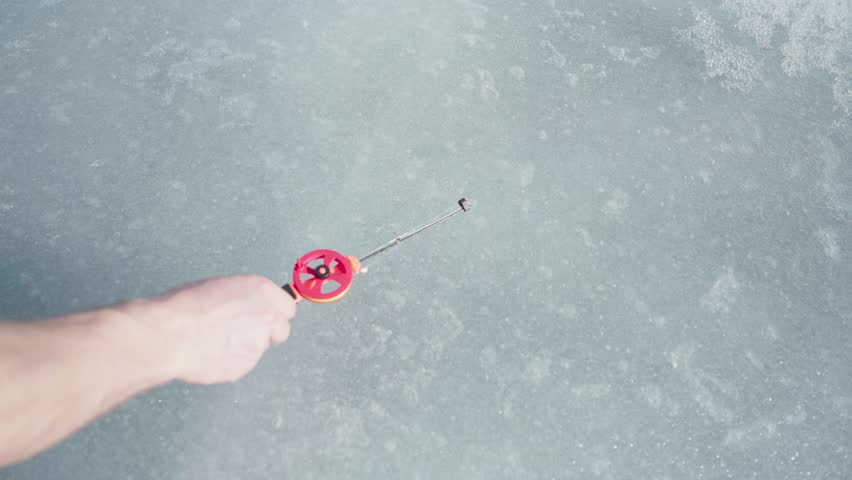 Ice Fishing Rod Lay Down On A Frozen Landscape. High Angle Shot