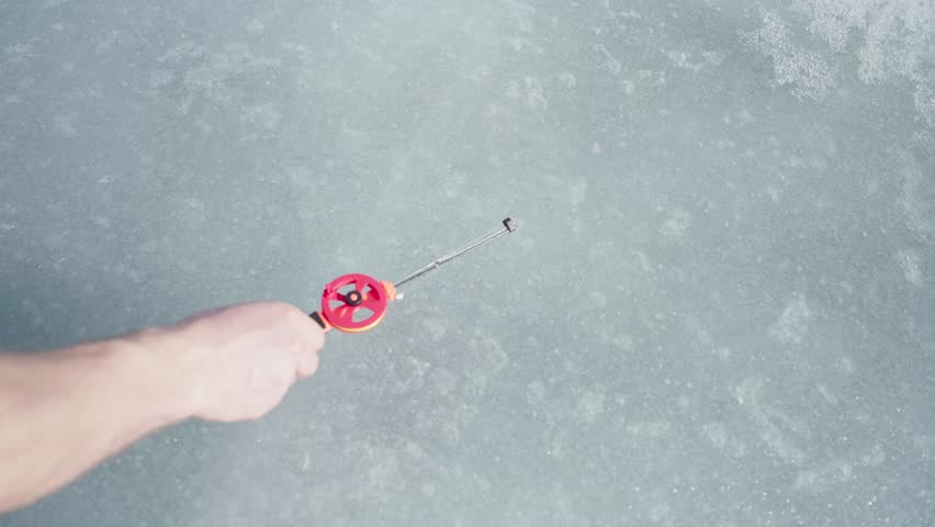 Ice Fishing Rod Lay Down On A Frozen Landscape. High Angle Shot Royalty-Free Stock Footage #3474193779