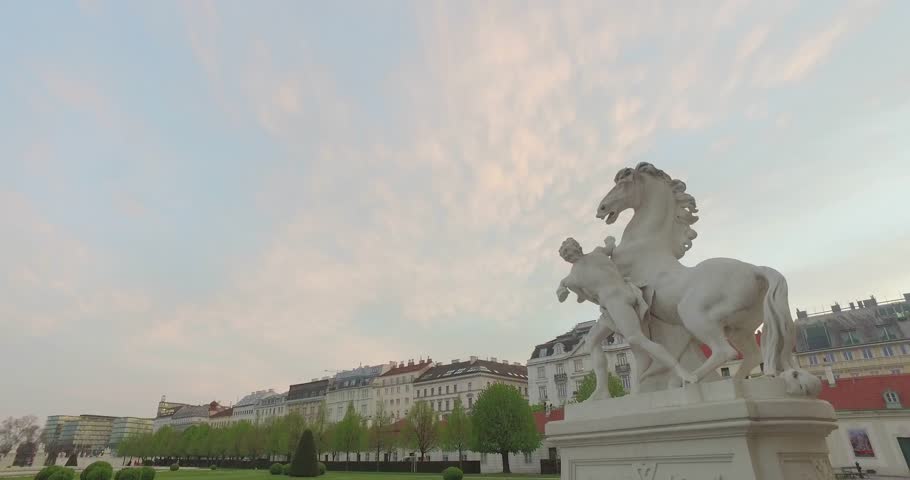 Statue of a man with a horse near the parliament in Vienna against the building
