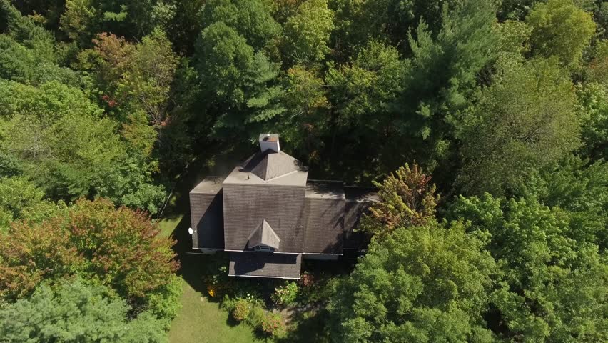 industrial pressure washing aerial view of water hitting the home 4k