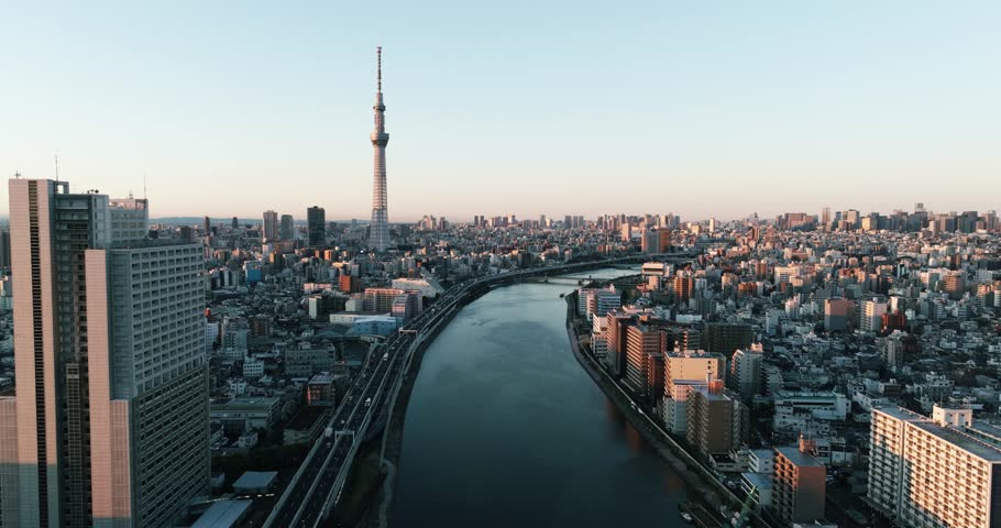 Video 4K of Sumida river and Building in Tokyo city Japan on sunrise. Tokyo is the capital of Japan. Tokyo has many tourist attractions. Japanese people are friendly. Cinematic color grading Japan.
