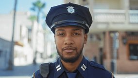 A confident african american police officer saluting outdoors in an urban setting. - Powered by Shutterstock - Get 15% off with code: PIKWIZARD15