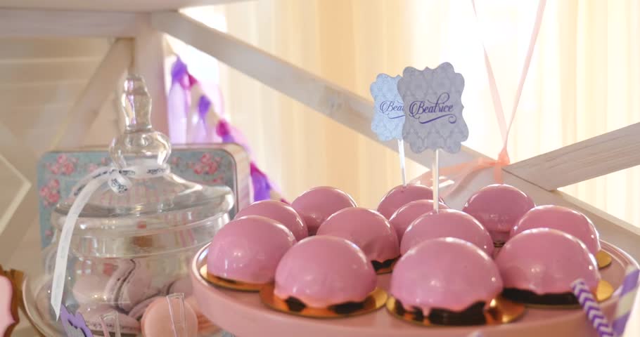 Pink cake pops on a dessert table at party or wedding celebration