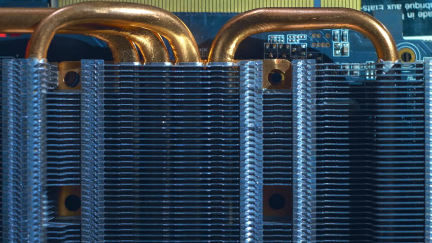 Powerful radiator with copper tubes for circulating coolant to cool the computer video card. Closeup. Macro 