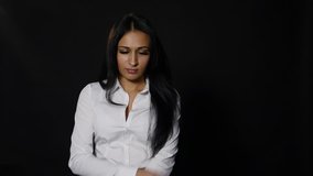 Frustrated upset young woman looking at camera isolated over black background