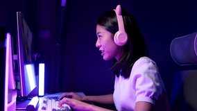 A young Asian woman is playing a game in a private room, stressed out because the game situation is tense because her team is about to lose, Try hard to win the game.