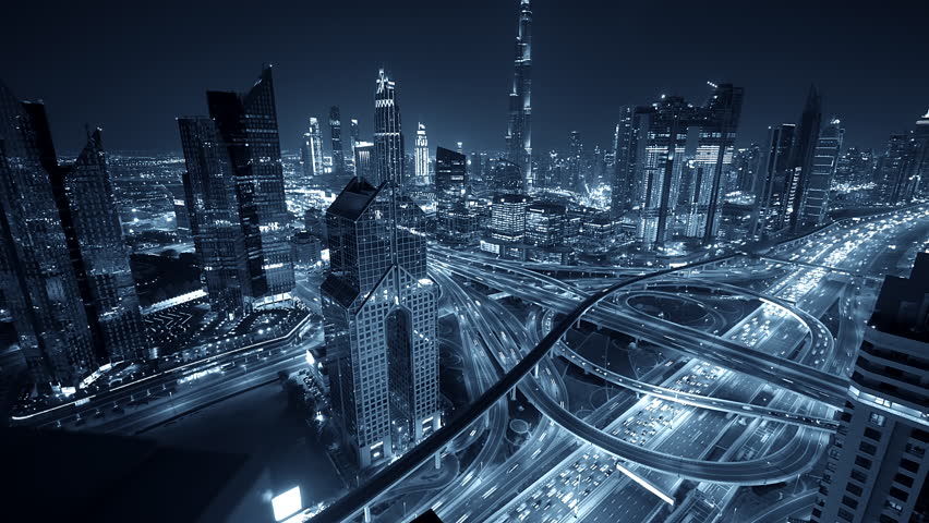 Aerial view of a busy city at night with glowing skyscrapers and urban design