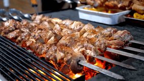 4K Video: Shish kebab cooked on the Grill on the Thailand night street market. Street food. Meat grilled on skewers. Barbecue party.