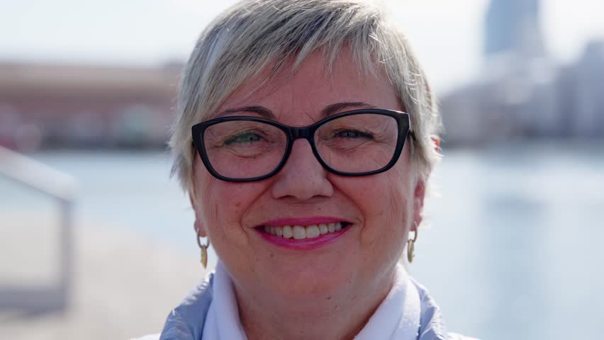 Portrait of happy mature woman laughing while looking at camera