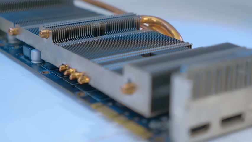 Powerful radiator with copper tubes for circulating coolant to cool the computer video card. Closeup. Macro. Shallow depth of field. Shot in motion 