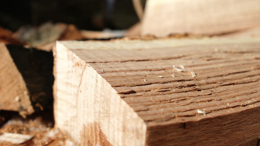 Close up of wood grains or fibers after splitting oak log into smaller piece preparing to be used as fuel source in cast iron stove to heat house through winter.