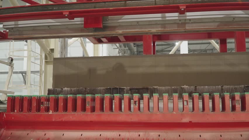 Moving the cut hardened mixture onto blanks for the production of aerated concrete blocks for subsequent processing Royalty-Free Stock Footage #3474706337