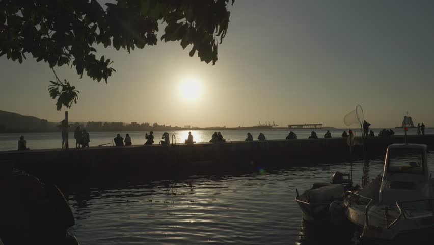 People Sitting on Pier Looking at Sunset in Tamsui District, Taipei, Taiwan