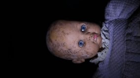 In the dark lies a scary old childish doll without hair, whose head is covered with mold. Looping endless video. Vertical, for smartphone. - Powered by Shutterstock - Get 15% off with code: PIKWIZARD15