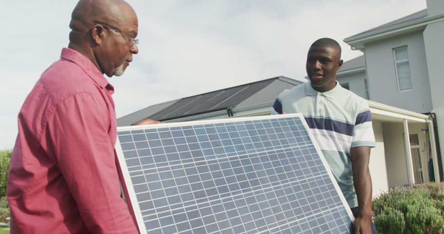 Video of african american men holding solar panel. Solar energy, green power and eco lifestyle concept.