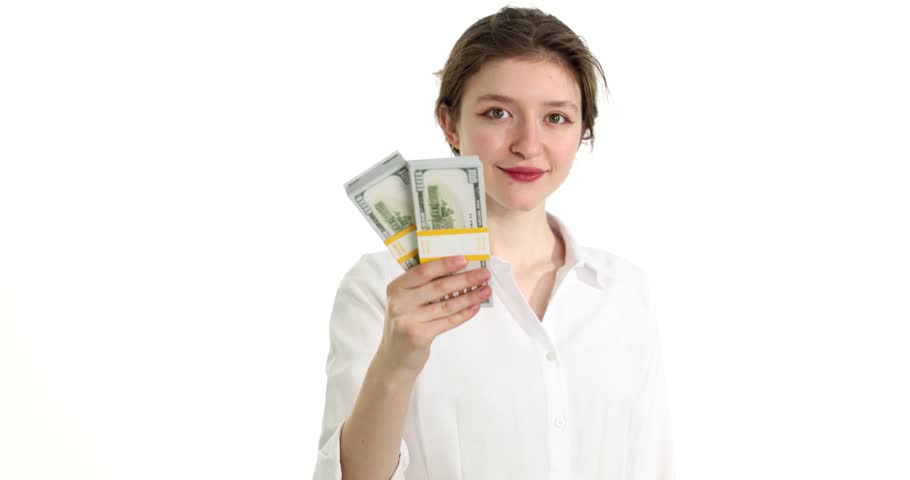 Young businesswoman holding bundles of dollar bills into camera on white background 4k movie slow motion. Good salary in business concept Royalty-Free Stock Footage #3474765499