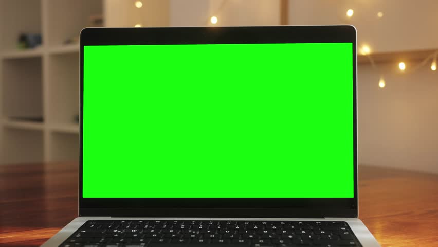Close up table of distant worker at home. Modern laptop computer with chroma key green screen. Royalty-Free Stock Footage #3474780355