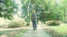 Senior man exercising in the park walking on the concrete floor has sudden knee pain osteoarthritis relieves the symptoms with gentle massage. - Powered by Shutterstock - Get 15% off with code: PIKWIZARD15
