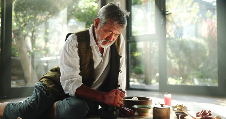 Person, herbal medicine and shaman for ritual for natural healing with spiritual alter with magic, herbs and apocathery. Male naturopath or holistic or traditional healer for sacred cleansing of mind