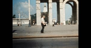 Arch VDNKh entrance in city Moscow. Retro 1980s Russia. Historic architecture landmark. Travel to famous, touristic building in street. Archival vintage color film. Old archive video. City tourism