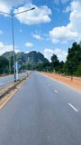 Driving down an empty countryside town road in krabi on a sunny day in thailand vertical portrait social media video