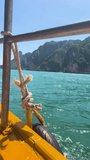 The side of a boat island hopping along gulf coast in thailand vertical portrait social media video