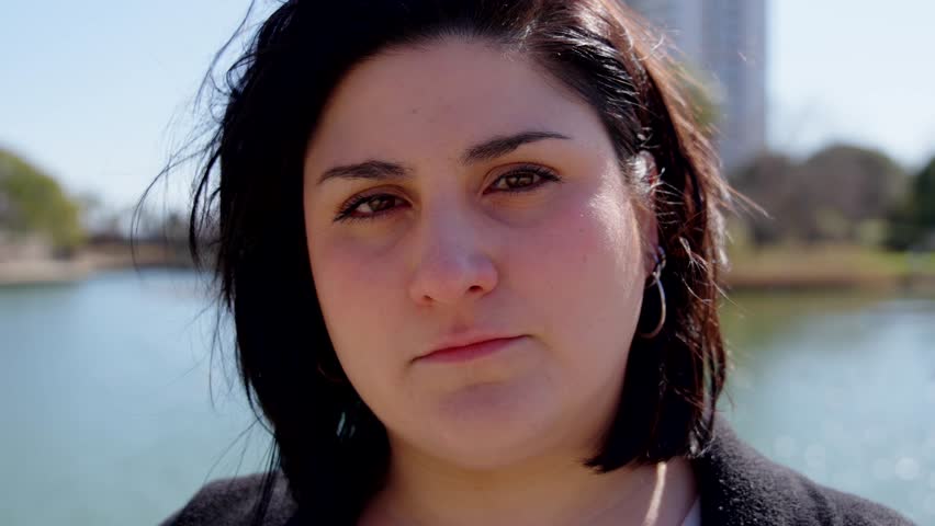 Portrait of serious curvy woman looking at camera