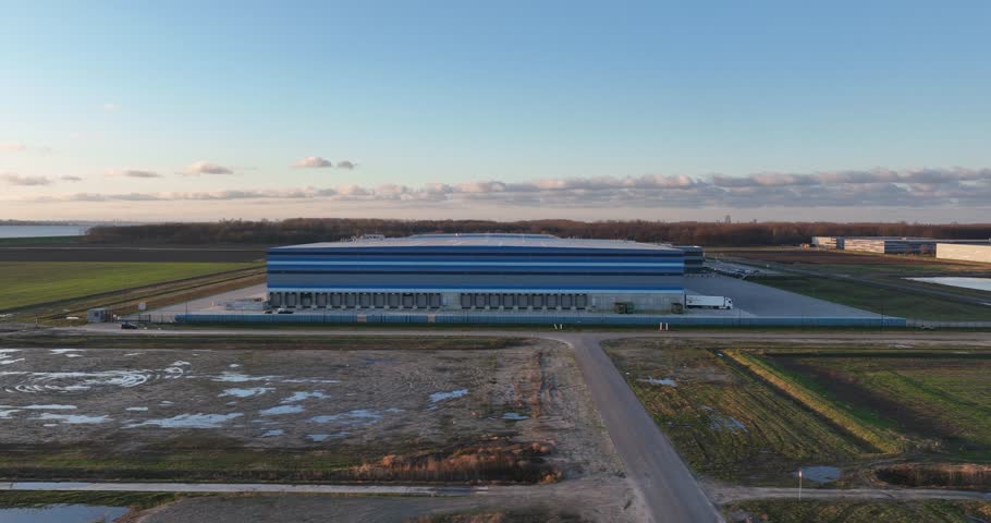 Modern new build distribution center for a supermarket chain in The Netherlands. Transportation over road by trucks. Storage and distribution of consumer products. Royalty-Free Stock Footage #3474943289