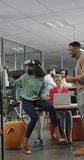 Vertical video of diverse business people talking and using vr headset in office. global business in creative office and body inclusivity.