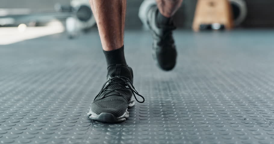 Runner, hands and tying shoes for exercise, training and workout or fitness with sneakers, fashion and getting ready. Person, athlete or jogger in closeup of laces, legs and feet for cardio at a gym