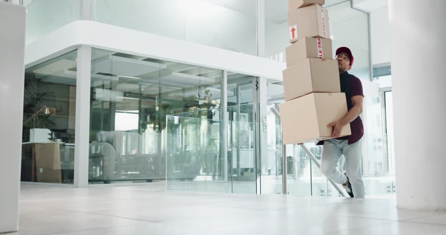 Delivery man, boxes and falling with package for accident, misstep and injury or mistake in a building or office. Courier worker or person with fragile stock for distribution risk, safety or balance