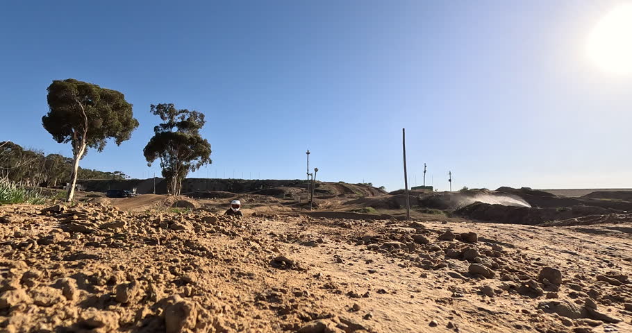 Motorcycle, jump or speed in off road, motorcross or training in safety, power or challenge on sand. Biker, dirtbike or leap in countryside, adventure or performance by professional sports talent