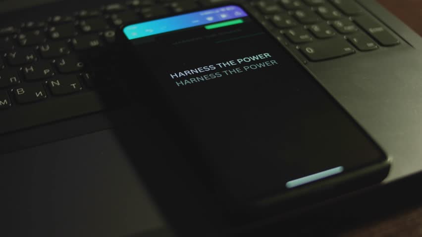 Harness the power of green energy. Clean Energy Initiatives. Inscription on smartphone screen. Graphic presentation with green neon color Energy symbol on black background. Power and energy concept Royalty-Free Stock Footage #3475207825