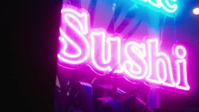 Luminous invitation: A neon sign in striking purple beckons diners to experience the flavors of sushi, creating a visually stunning display - Powered by Shutterstock - Get 15% off with code: PIKWIZARD15
