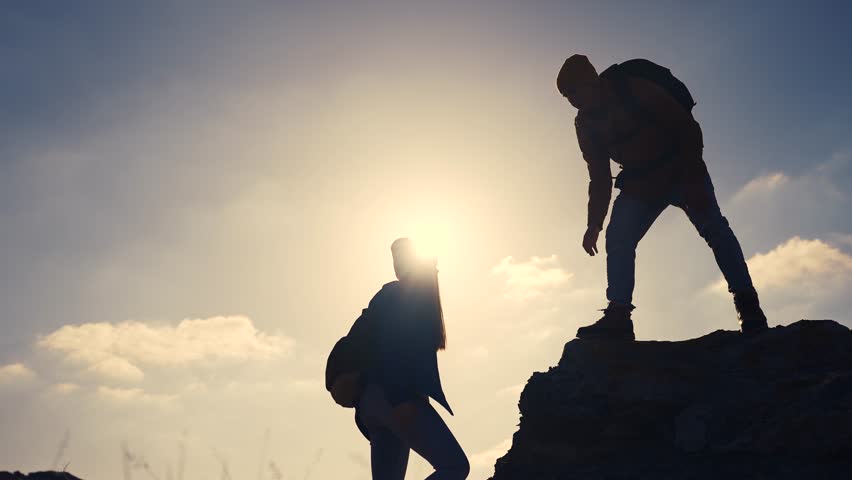 business. teamwork helps hand down business silhouette concept. a group of tourists lend a helping hand, climbing rocks, mountains, lend helping hand. teamwork people climbers climb to top travel Royalty-Free Stock Footage #3475320441
