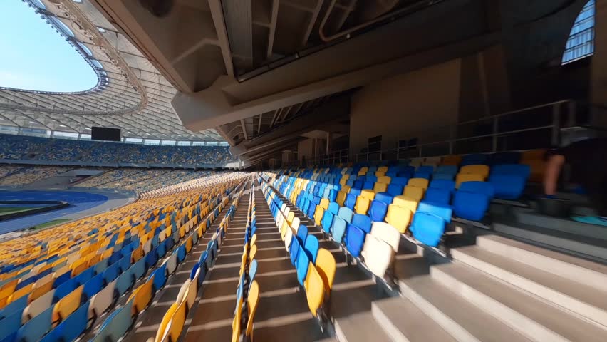 FPV flight, Stadium. cityscape time of day night. The view from the top to the illuminated stadium with games and fans. Stadium, Kiev, Ukraine, Soccer stadium field, soccer background, outdoor sport 