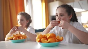 children group oranges fruit food in kitchen. healthy eating concept. children girls eat oranges cut into slices in the kitchen indoors. oranges fruit concept lifestyle - Powered by Shutterstock - Get 15% off with code: PIKWIZARD15