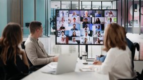 Group Of Businesspeople Having Video Conference With Another Business Team
