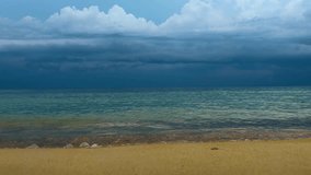 Low angle ground level pov Idyllic tropical beach with turquoise seawater of Caribbean sea with yellow sand beautiful shore on cloudy stormy day