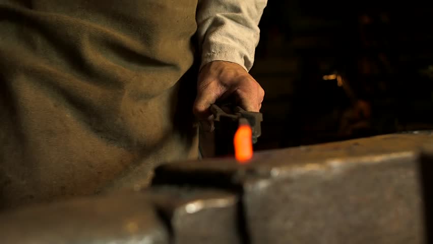 Blacksmith Forges Red Hot Metal Bar on Anvil. A Blacksmith is a Metalsmith Who Creates Objects Primarily from Wrought Iron or Steel, but Sometimes From Other Metals.