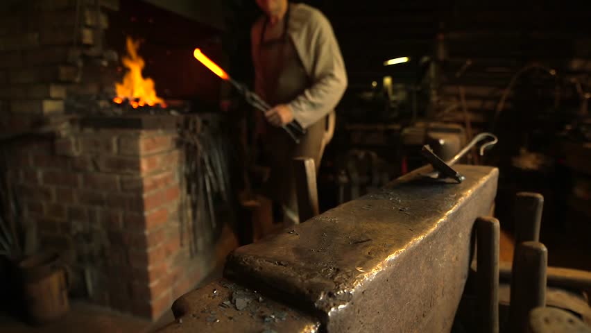 Blacksmith on an Anvil Forges Hot Iron, Makes a Horseshoe. A Blacksmith is a Metalsmith Who Creates Objects Primarily from Wrought Iron or Steel, but Sometimes From Other Metals.